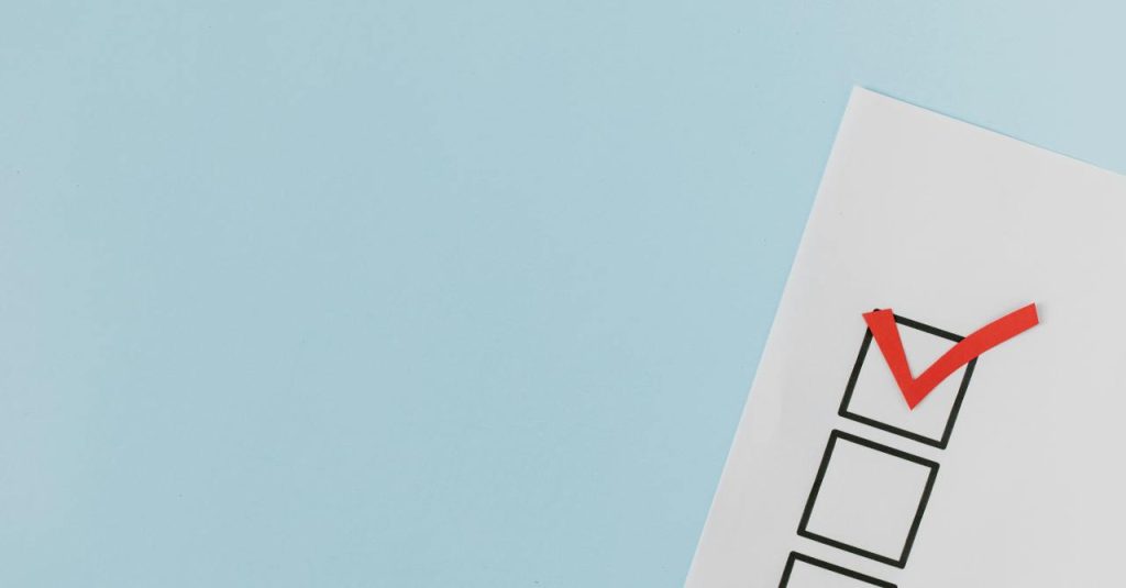 A checklist with a red checkmark symbolising a completed task on a pastel blue background.